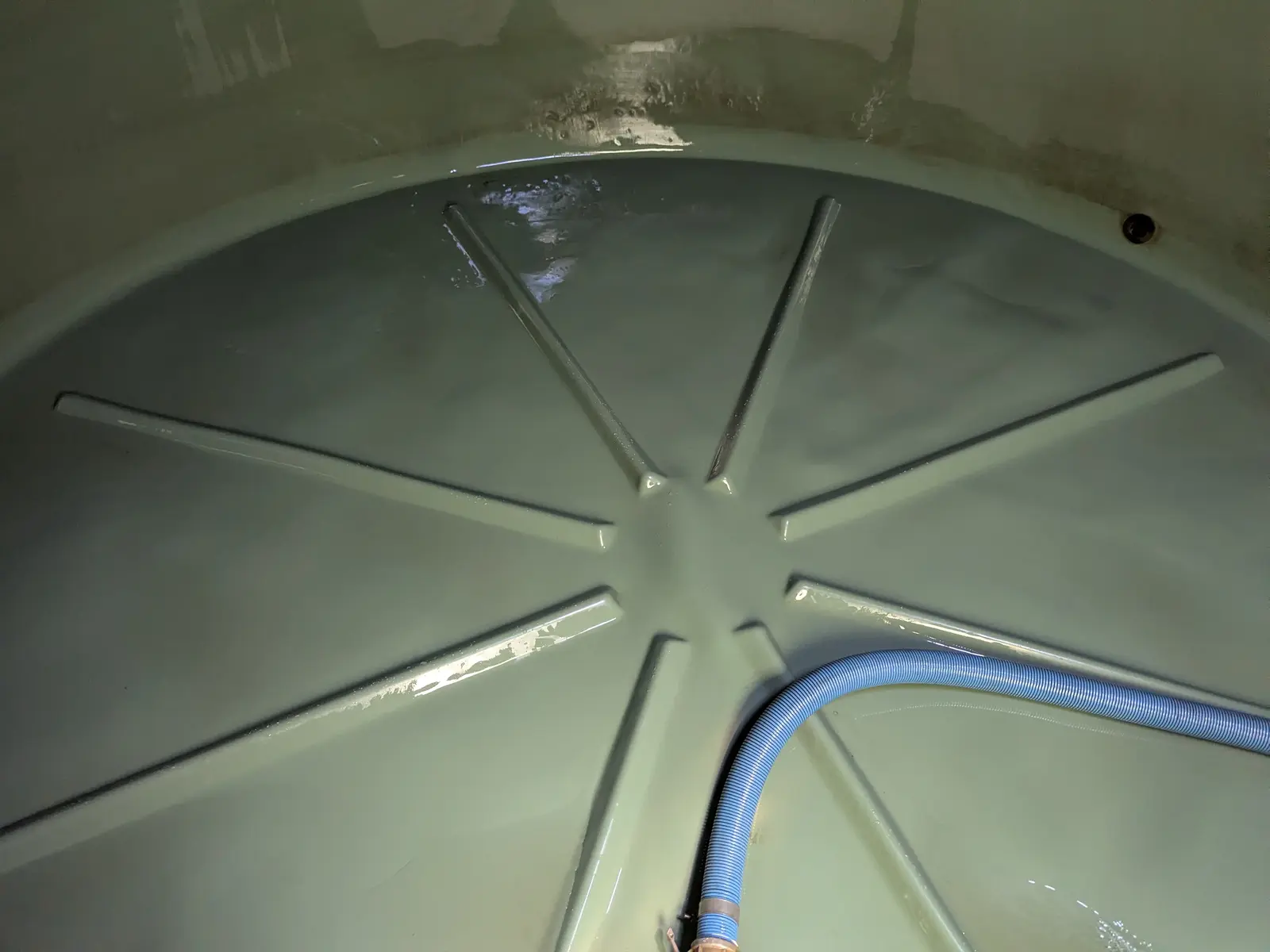 Clean concrete tank floor after the organic matter was vacuumed out